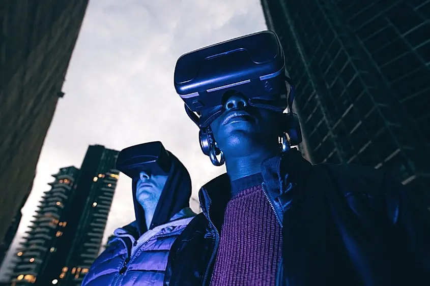 Two people exploring the metaverse using virtual reality goggles.