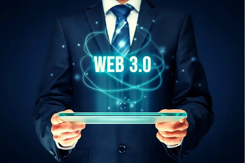 NFT domain. A man standing holding a tablet with the words Web 3.0 illuminating from the screen.