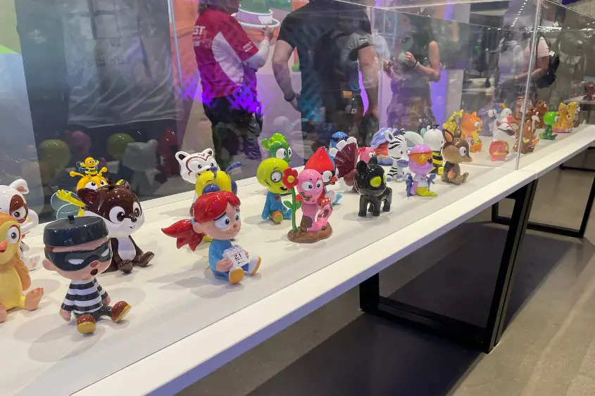 Numerous VeeFriends characters in a case at VeeCon.